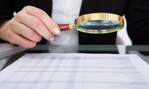Businesswoman Holding Magnifying Glass