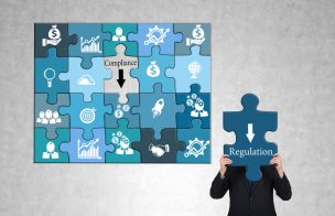 Regulation and compliance concept with business icon puzzles and businessman on concrete background